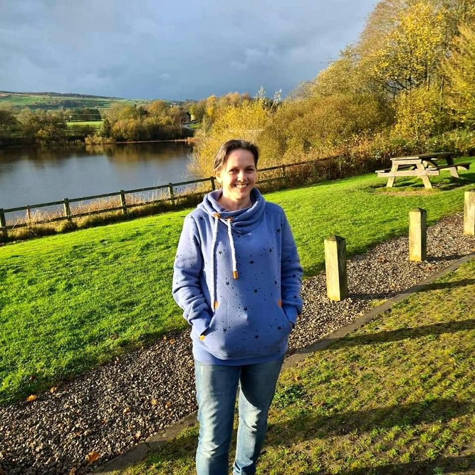 Jude, acupuncturist, standing by a lake